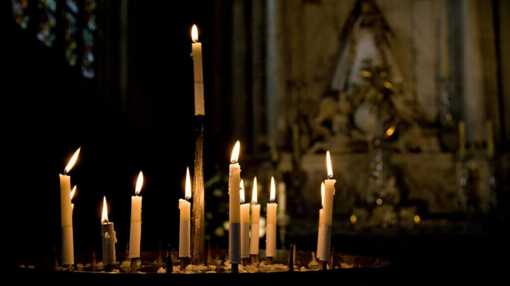 tall candles burning in a church