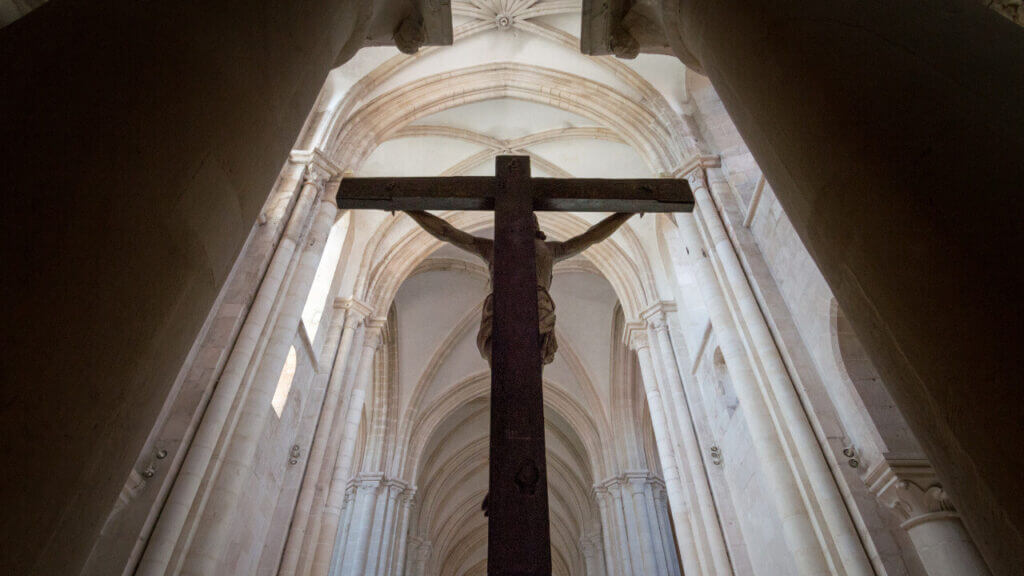 view from below and behind a large crucifix in a church