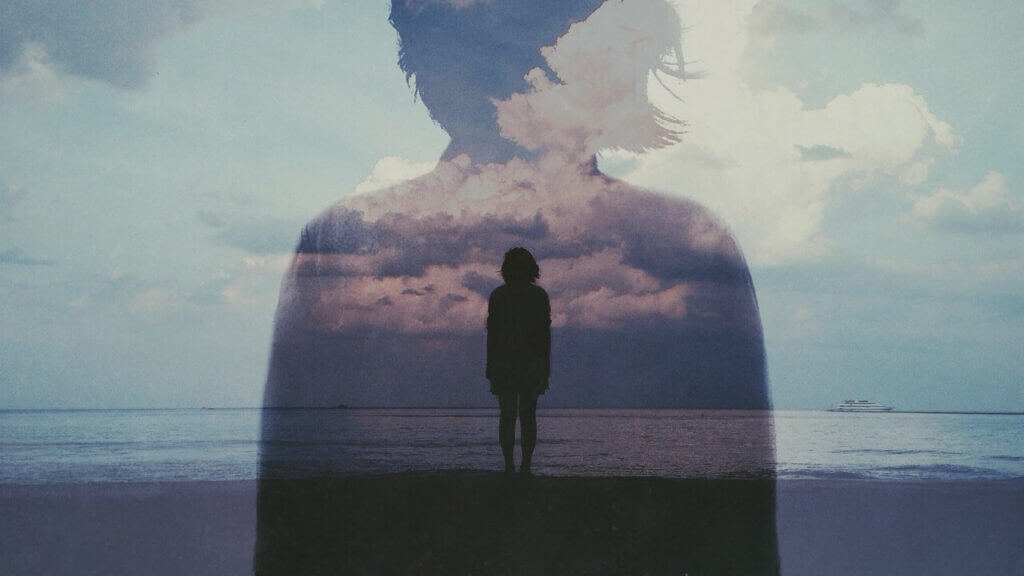 a person standing at the edge of view with a bigger image of their silhouette overlayed