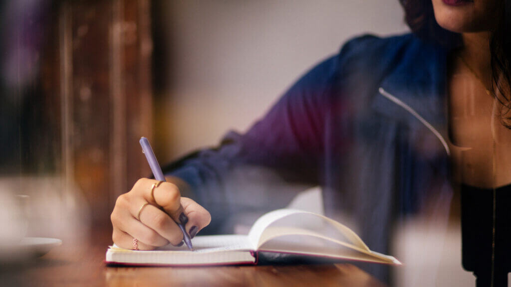 a woman writing in a journal