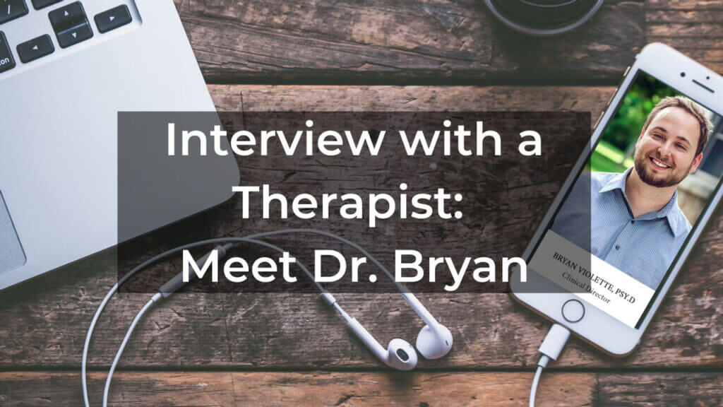 image of a desk with computer with text overlay that says interview with a therapist Meet Dr. Bryan