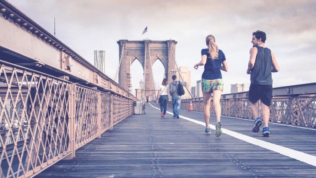 man and woman jogging across a bridge New Year's resolutions